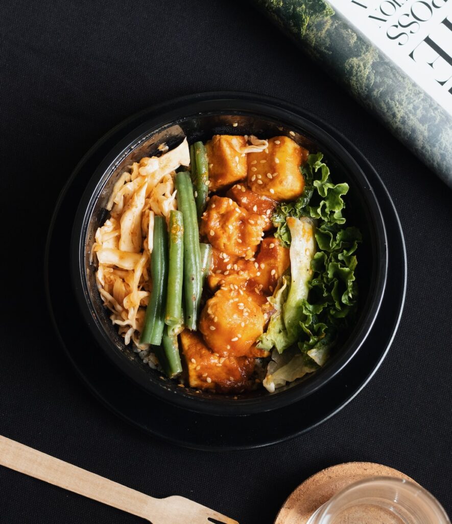 tofu & vegetable stew in black ceramic bowl