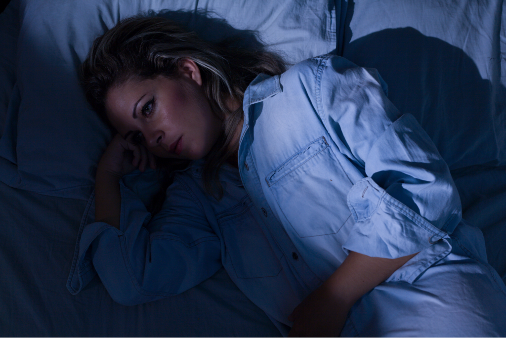 woman laying awake in bed at night