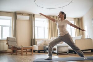 a woman practicing yoga in her apartment