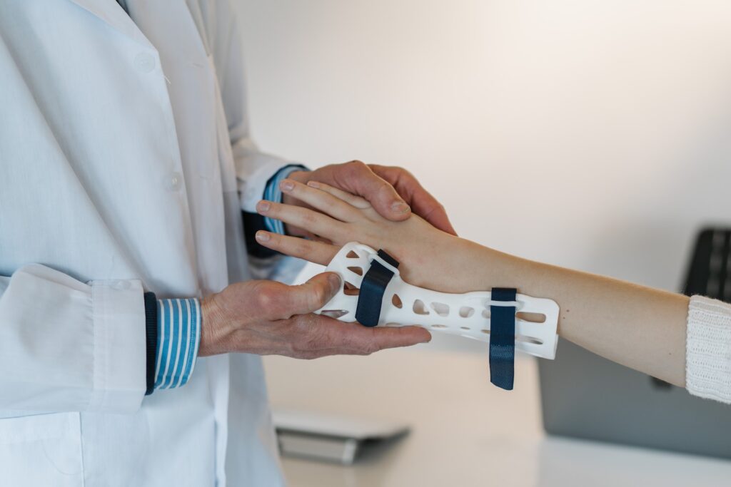 close up view of a doctor placing a cast on a child's wrist.