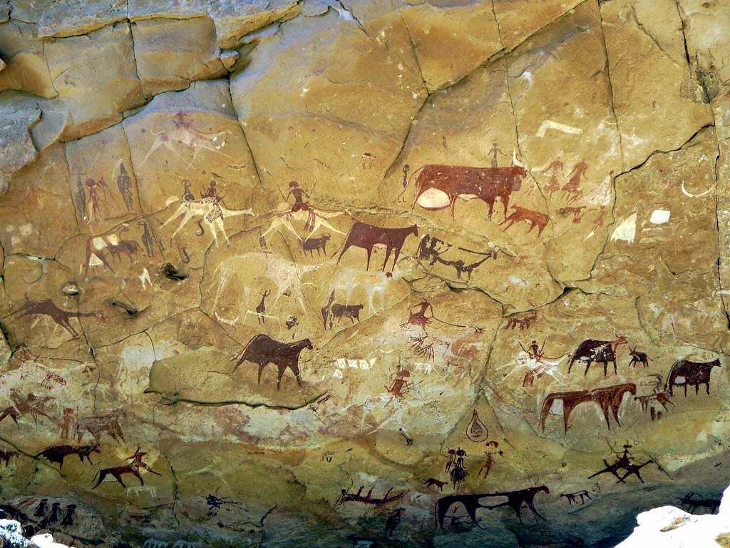 prehistoric paleolithic cave paintings showing cows and hunters 