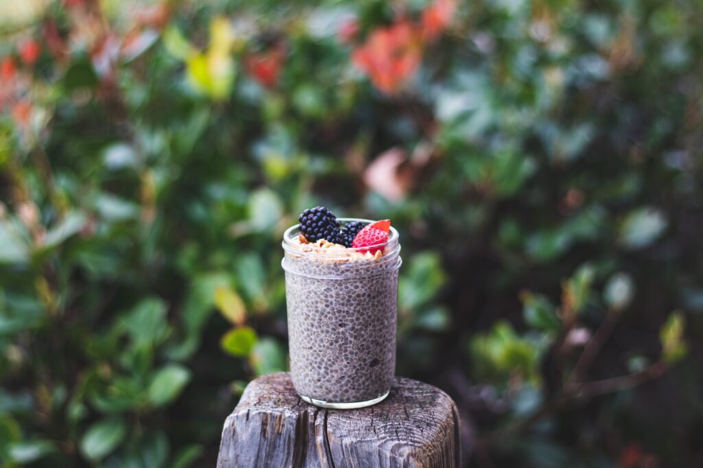 chia pudding in a glass mason jar with berries on top