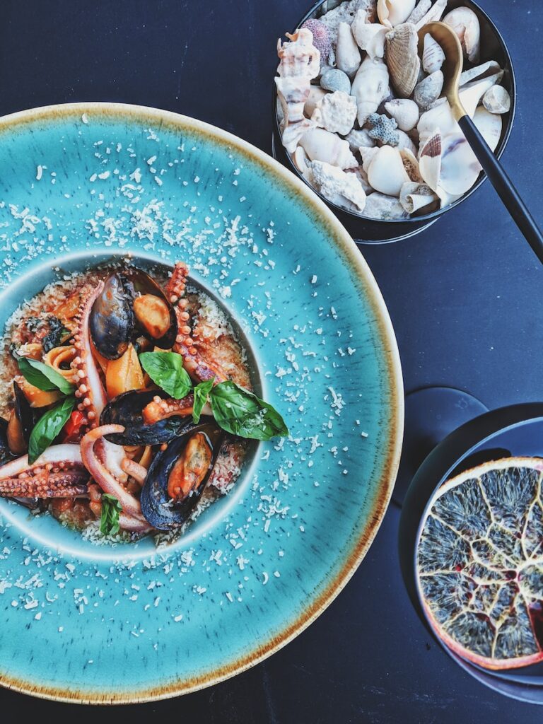 a bowl of seafood including shrimp, octopus, and mussels